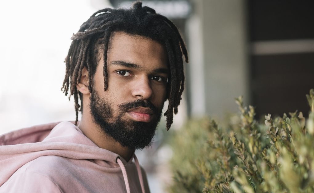 Men’s box braids styled with a clean taper fade on the sides for a sharp and modern look.