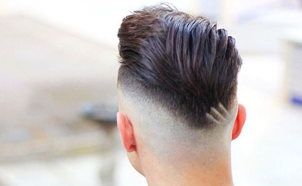 Clean nape fade haircut for men, focusing on a smooth taper at the base of the neck for a neat finish.