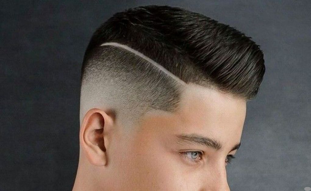 "A low-maintenance and masculine undercut hairstyle fade featuring a uniform short buzz cut on top that seamlessly blends into a sharp skin fade."