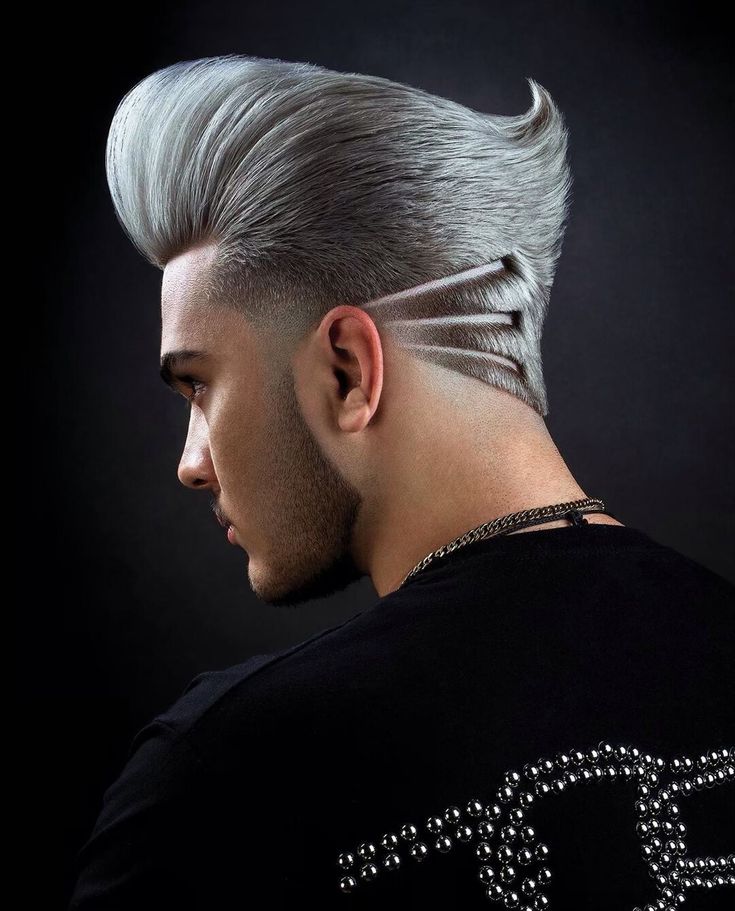 "A trendy and high-fashion undercut hairstyle fade featuring hair dyed in a striking silver or grey shade, creating a bold aesthetic against the dark, faded sides."