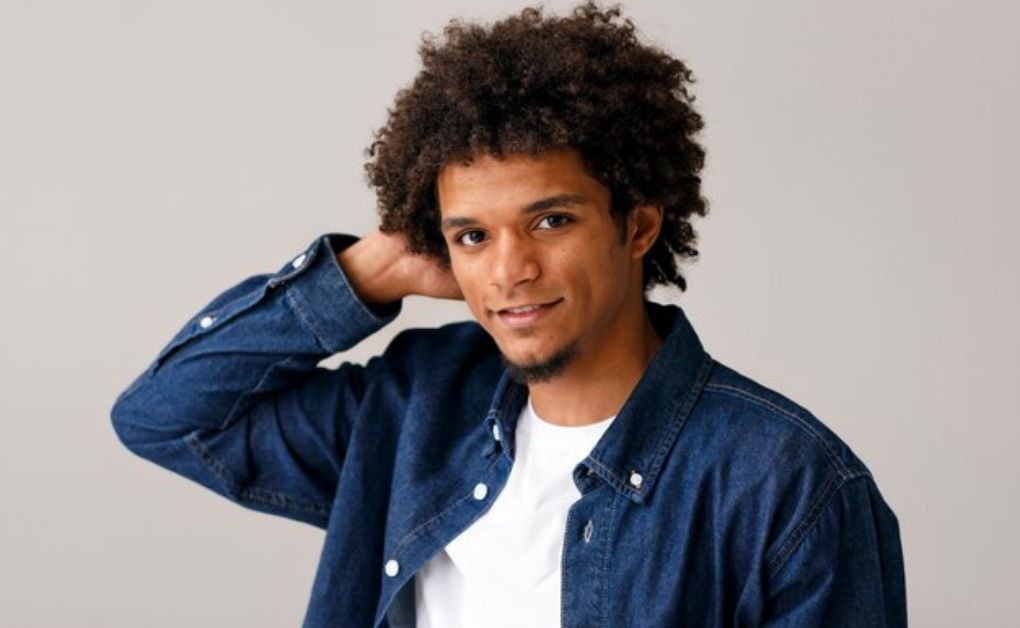 Black men’s hairstyle featuring defined sponge twists on top with a balanced mid fade on the sides.