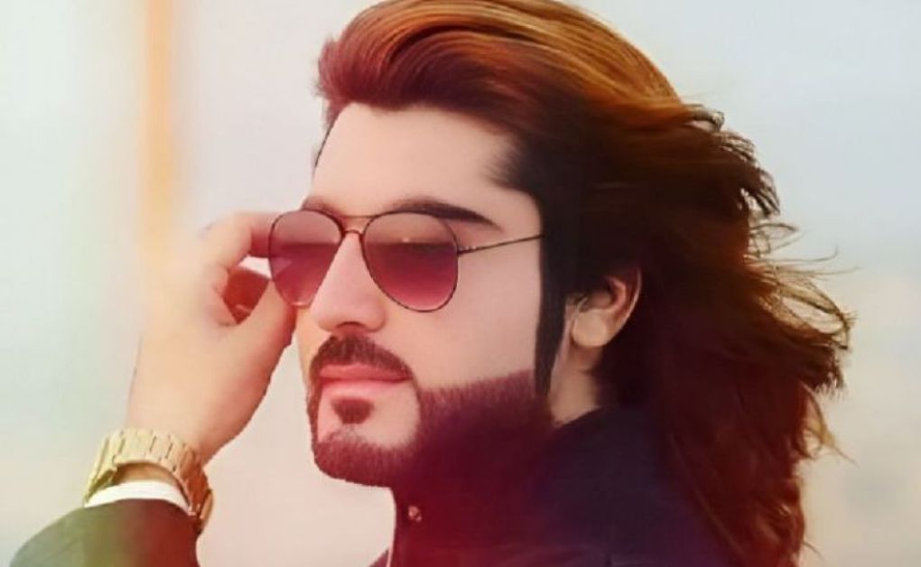 Modern men’s hairstyle featuring long dreadlocks on top with a sharp, high-contrast fade on the sides.