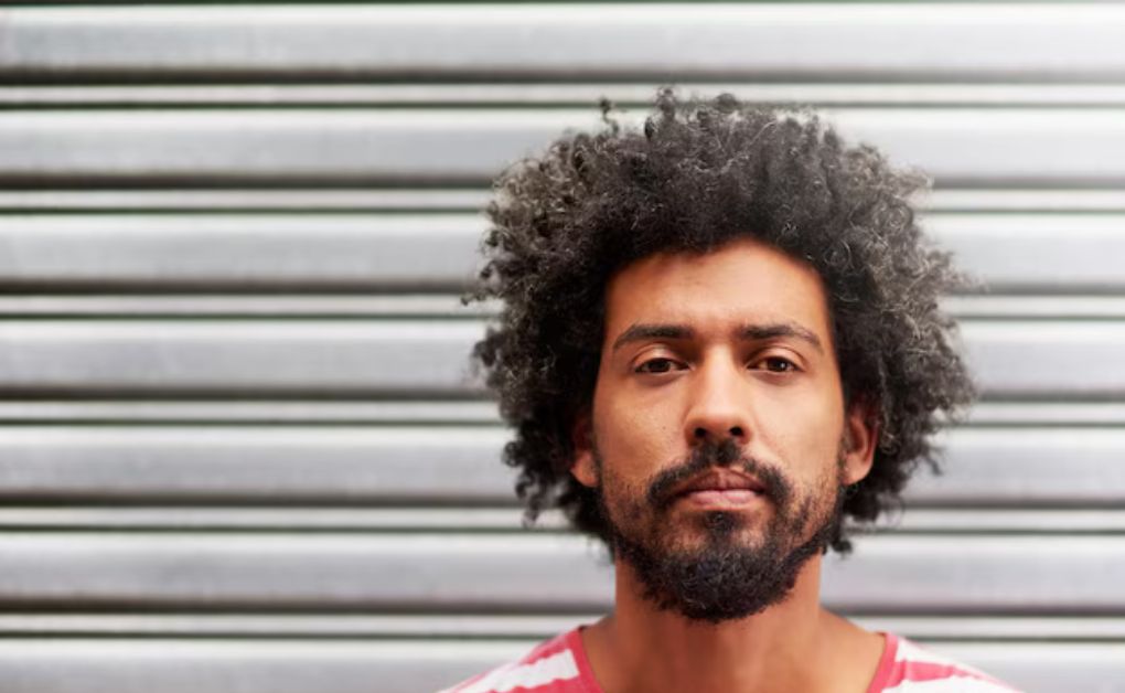 Curly Hairstyles for Men: Top Looks for Every Hair Length curly man bun (1)