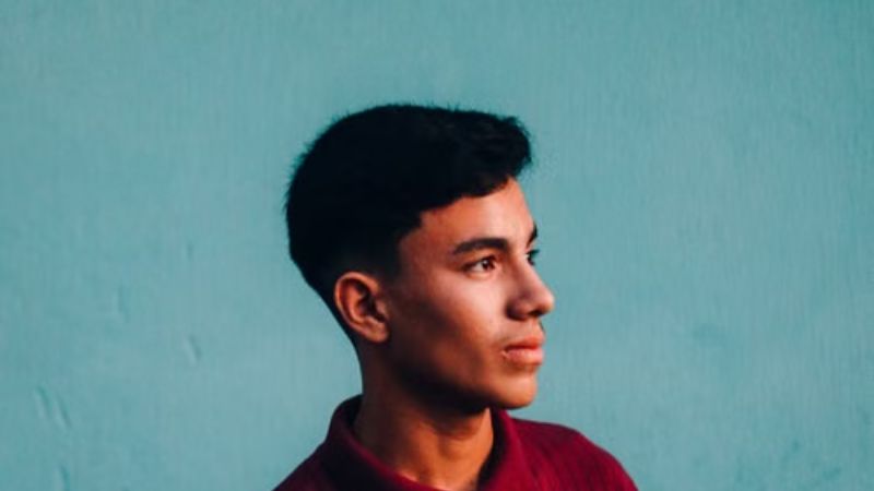 mid taper fade with a middle part
